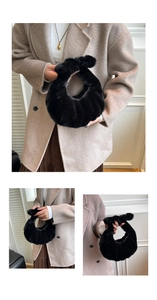 Close-up of black faux mink fur handbag showing soft vertical pleated texture and crescent shape
