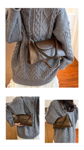 Macro detail of vintage brown leather crossbody bag with thick bronze chain and metal hardware