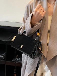 Chic black shoulder bag with matte leather flap and vintage gold twist lock closure
