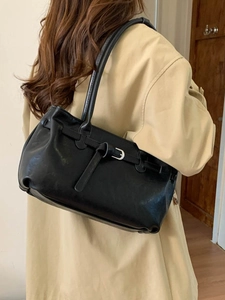 Classic black leather tote bag with adjustable buckle strap and spacious interior design