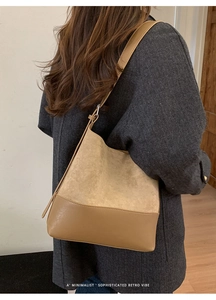 Detail of vintage brown shoulder bag showing contrast textures of leather and suede