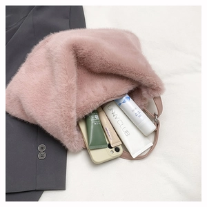 Interior view showing the large storage space of the pink plush faux fur tote bag