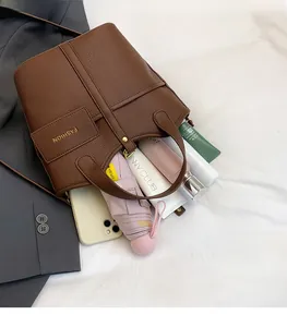 Detailed interior of a brown leather bucket bag showing large storage capacity