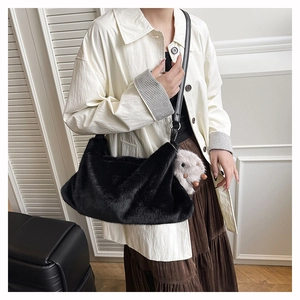 Detail of black faux fur shoulder bag with leather strap and cute animal plush charm