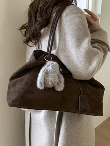 Minimalist dark brown suede tote bag for women worn with grey coat for autumn