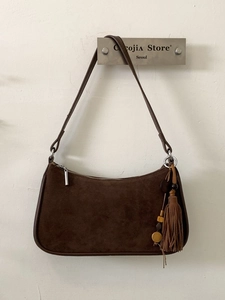 Brown suede minimalist crossbody bag with retro tassel charm and bohemian design accents