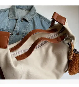 Detail of canvas tote with sturdy leather handles and secure zip closure