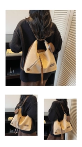 Detail of beige canvas crossbody bag with brown leather trim and detachable coin purse