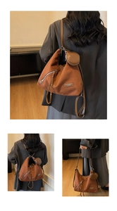Brown suede tote bag detail with round coin purse and fashion logo strap close-up