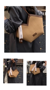 Detail of woven tote bag featuring herringbone texture and brown leather trim accents