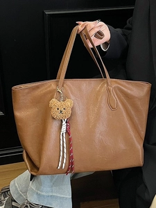 Brown large capacity faux leather tote bag with plush bear charm for daily commute