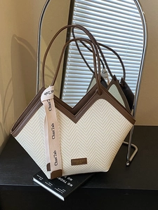 Retro cream woven tote bag with brown leather handles and decorative silk ribbon
