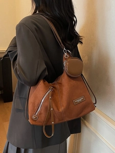Brown suede hobo bag with mini purse and side zipper detail for casual daily style