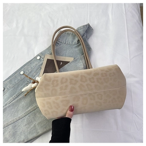 Detail shot of leopard print faux leather tote bag with sturdy dual handles and large capacity