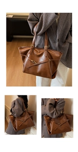 Detail of vintage brown tote bag with decorative cross straps and golden metal hardware