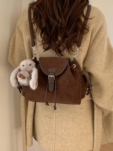 Vintage brown suede bucket backpack with retro buckles and cute plush rabbit pendant