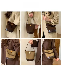 Detail showing vintage suede bucket bags in brown and khaki with metallic hardware