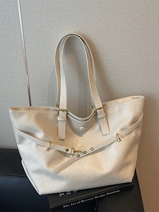 Vintage off-white tote bag with wrinkled texture and adjustable shoulder strap