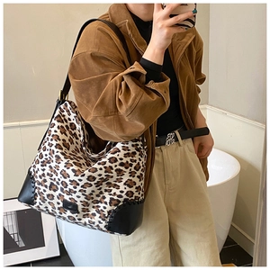Detailed view of leopard print tote bag with reinforced leather corners and stitching