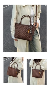 Detailed view of dark brown woven handbag with wooden bead tassel and adjustable strap