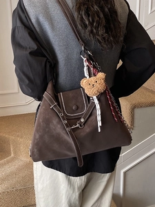 Brown suede large shoulder bag with white stitching and cute plush bear charm