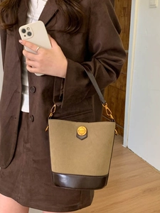 Vintage khaki suede bucket bag with brown leather trim and golden logo detail