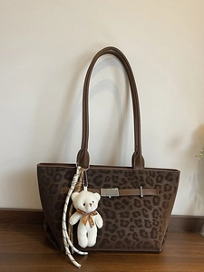 Leopard print suede tote bag with leather straps and plush bear charm for daily commute