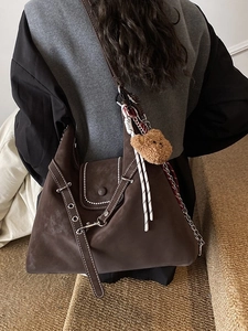 Large brown suede tote bag with white contrast stitching and wide grommet strap