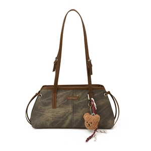 Vintage dark brown shoulder bag with leather straps and a cute plush bear charm decoration
