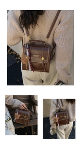 Detail view of dark brown leather backpack with bear charm and plaid scarf accessory
