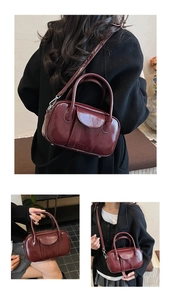 Detail of dark burgundy glossy leather handbag with crossbody strap and silver hardware