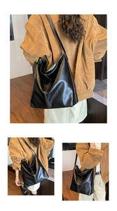 Détail d'un grand cabas noir en cuir avec surpiqûres blanches contrastées et plis souples