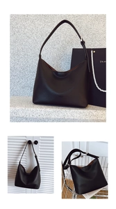 Detail of black lychee grain leather hobo bag with adjustable strap and silver hardware