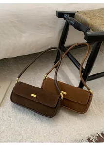 Détails des sacs baguette vintage en daim café et camel avec des boucles dorées chic