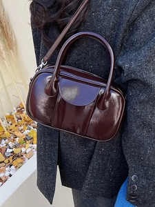 Deep red-brown patent leather Boston bag with silver hardware for autumn street style