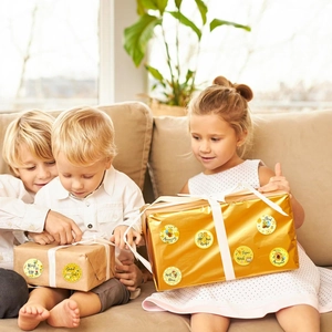 Kids smiling and opening gift boxes decorated with cute honeybee reward stickers
