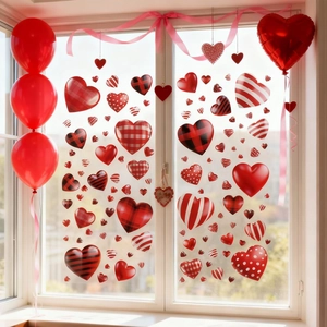 Detail of red and plaid heart-shaped window stickers on glass for Valentine's Day decor