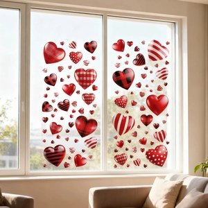 Detail of diverse heart-shaped window stickers on glass in a cozy modern living room