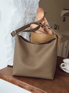 Chic khaki pebbled leather hobo shoulder bag styled in a cozy lifestyle setting