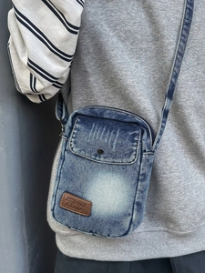 Casual denim crossbody phone bag in deep blue with adjustable shoulder strap and logo
