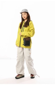 Outdoor leisure look with yellow waterproof jacket and mini vertical crossbody bag