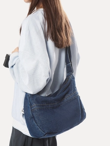 Deep blue denim shoulder bag in a large crossbody hobo style with wide strap for women