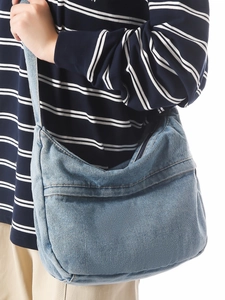 Minimalist light blue denim crossbody crescent bag with wide shoulder strap for women