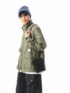 Army green cargo hooded jacket and black crossbody bag in urban techwear style outfit