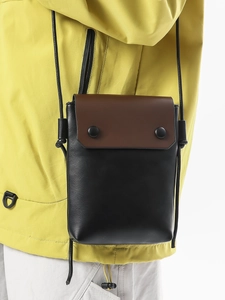 Vertical canvas phone crossbody bag with brown flap and black round snap buttons