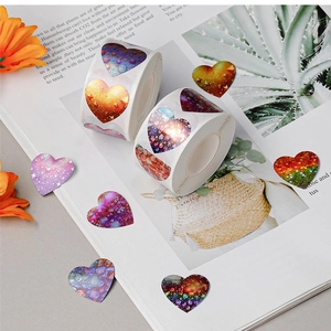 Sparkly heart-shaped glitter gift stickers in rolls for Valentine's and wedding decor