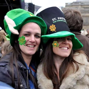 Close-up of green St. Patrick's Day clover stickers and themed party accessories set