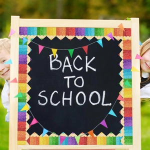Scalloped rainbow glitter bulletin board borders on blackboard with kids in a park background