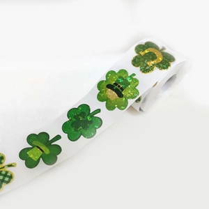 Macro shot of laser green four-leaf clover stickers for St. Patrick's Day gift wrapping