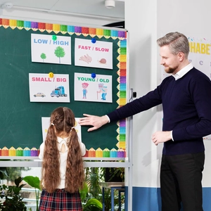 Classroom scene showing colorful pencil bulletin board borders used on a green chalkboard